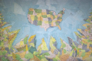 Map of the USA surrounded by water and then states/countries surrounding the USA with jagged edges